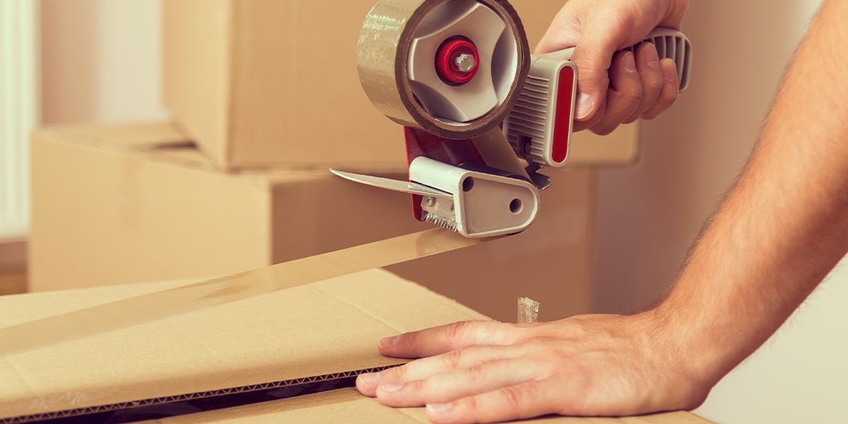 Individual using packaging tape for their shipments