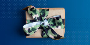 Packaged wrapped with camo ribbon on a blue mat